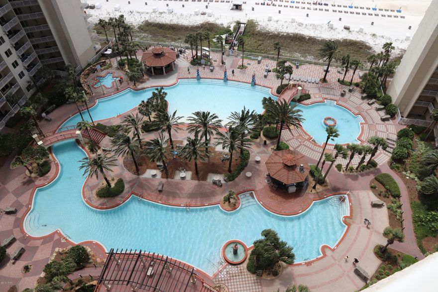 CURRENTLY UNDER CONTRACT, SELLER ACCEPTING BACKUP OFFERS.  UPGRADED, beautiful wood-look tile flooring throughout.   FULLY FURNISHED and RENTAL READY.  Master bedroom and living room are both GULF-FRONT.  Huge balcony, twice as wide as a typical 1bd condo.   King-size bed.   The large chair is also a pull-out sleeper.  2nd bedroom is really a converted bunk-room with a window, a closet and a door.  Currently on the Resort Collection rental program and cannot cancel out of that agreement until the end of July.