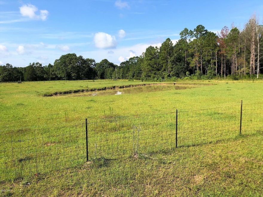 Gorgeous 6.6 acres of cleared pasture land with pretty trees close to Chipley. There are two parcels here being sold together. One parcel is 3 acres on the corner of Joiner and Wildwood Cir. This parcel features frontage on two roads,  highway frontage on one side, and a pond for cattle. The second parcel is 3.6 acres and features a well and power. Both parcels are completely fenced and crossed fenced. This land is already set up for livestock or is a beautiful spot for a homesite close to Falling Waters and all of the conveniences Chipley has to offer. Bring your livestock or build your building plans and make this land yours today!