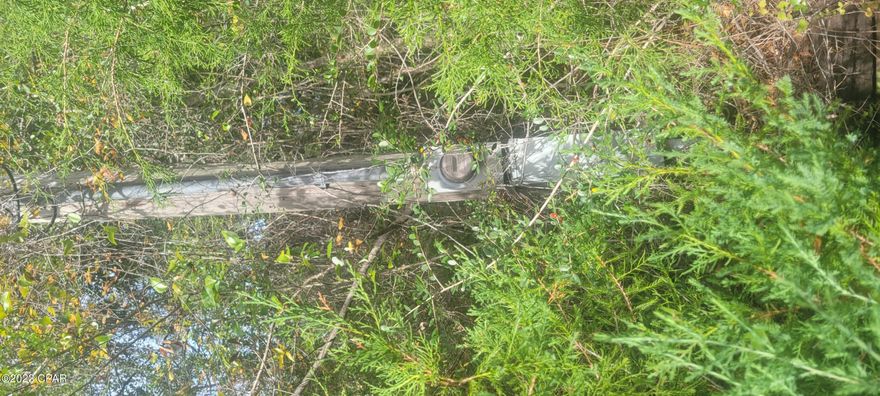 Just over an acre parcel in the exquisite Compass Hills subdivision that is close to Compass Lake Lodge.   HOA is voluntary at $135 per year, which gives you access to all the lodges amenities, swimming pool, boating access, fishing, camping and restaurants .   This is a great area to build your home and be apart of this community.   Just 20 min to Marianna, 35 min to Panama City and 45 min to Panama City Beach.   There is electric pole already existing on property and abandon well and septic.   Paved road access, no muddy dirt roads to worry about here!  Buyer to verify all measurements if important to buyer.  This community is deed restricted to site built homes only with a minimum of 1000 sq ft heated and cooled.