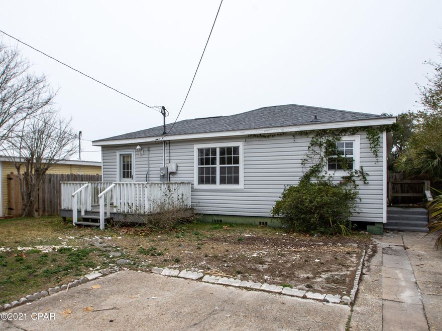 FIXER UPPER or tear-down! This is a fantastic opportunity to secure a great location on the east end of Panama City Beach with no HOA. This home has been taken down to the studs and is ready for a complete renovation or tear down the existing residence to build the beach home of your dreams. Perfectly situated in a non-rental community just one block from beach access and directly across from a public park with a playground, a shuffleboard court, picnic pavilions with BBQ grills, and lots of green space. The beautiful back yard boasts gulf views, mature oak and palm trees, privacy fencing, and a spacious screened porch. The existing 3-bedroom, 2-bath floor plan is the perfect blank canvas to make your own or demolish the existing structure to build your dream beach home from the ground up.