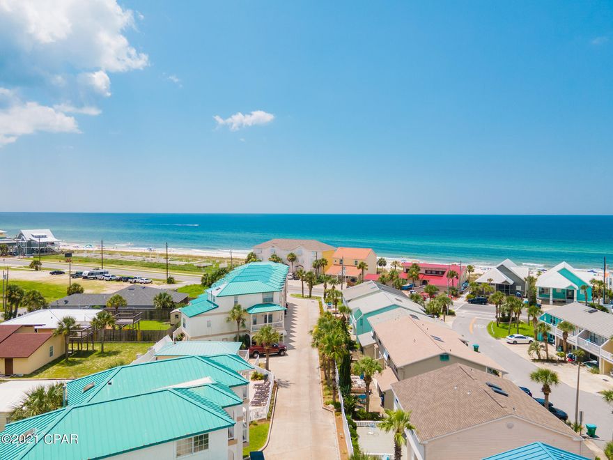 This 3 bedroom, 3 bathroom townhome features a lock-out efficiency suite making the possibilities endless. Live in one unit and rent the other or maximize its potential and rent out both! The efficiency has a separate entrance and includes a full size refrigerator, microwave, and sink along with a full bathroom. The second floor hosts the main living area with a beautifully updated kitchen, wrap around balcony, guest bedroom big enough to sleep 5 and a full bath. Large windows stretch high, immersing this unit in natural light. Beautiful Gulf views greet you from the private balcony in the master suite, complimented by a gas burning fireplace, vaulted ceilings with exposed beams, and a large walk in closet. Just a few steps to community pool and gulf