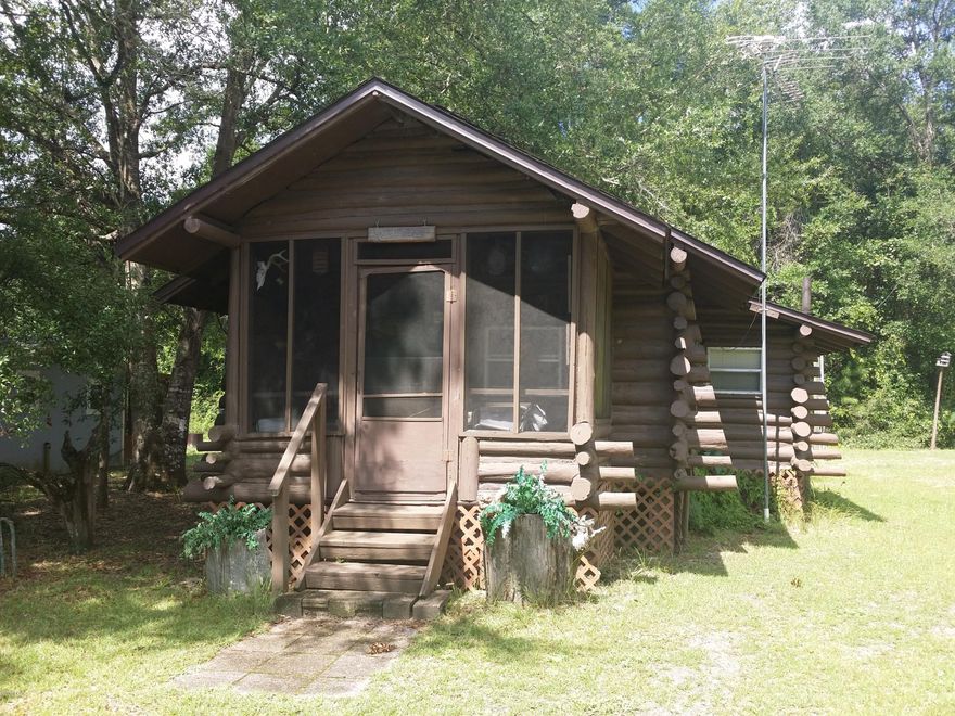 ALL SIZES TAKEN FROM TAX ROLLS////PLEASE VERIFY////A TRUE BLUE LOG CABIN!!! ABSOLUTLEY ADORABLE COZY CABIN TO ENJOY THE WEEKEND AWAY AND GO FISIHNG ON THE RIVER THAT IS A VERY SHORT DISTANCE!!! THE RIVER BANK IS FAR ENOUGH AWAY SO YOU WILL NOT WORRY ABOUT FLOODING, YET CLOSE ENOUGH TO WALK! THIS CABIN IS SET UP AND READY TO GO! FULLY FURNISHED, BED, TV, DISHES,EVERYTHING!!! A VERY NICE SCREENED IN FISH CLEANING AREA/COOK HOUSE IN THE BACK!!SELLER STATES ROOF IS LESS THEN 4 YEARS OLD,APPLIANCES ARE LESS THEN 4 YEARS OLD. HAD BLOWN IN INSULATION PUT IN THE ATTIC!!!! CAN NOT BEAT THIS PRICE!!!!! YOU CAN HAVE CLOSE ACCESS TO THE APALACHCOLA, CHIPOLA RIVERS AND INTERCOASTAL WATERWAY!!SELLER SAYS BRING ALL OFFERS!! NEEDS TO SELL ASAP!!!!!!!!!!!!
