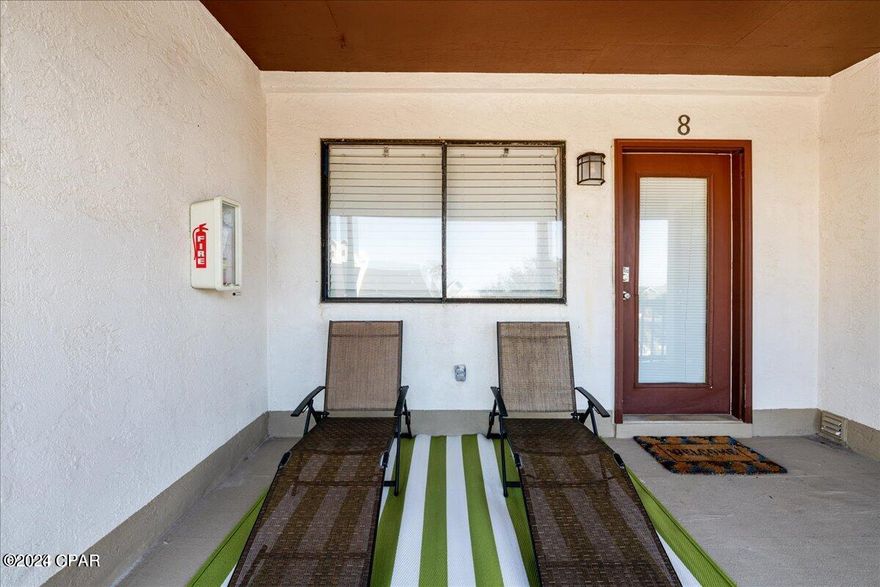 Sand Castle Villa Unit 8 is a fully stocked and fully furnished efficiency condo that is turnkey and ready for any owner. This condo unit has a high short term rental income as it is a STR, as does this complex.  Ask agent for more details.  With creative marketing you can stay fully booked year round!  The peace and tranquility of this property and of this condominium makes for unforgettable memories that can be made at the beach. Located just 150 steps from the white sugary sands and the warm gulf waters easy access to the beach is at your doorstep. Beach access 13 and 14. The beautiful decor in this unit features tile floors throughout, beautiful furnishings with a luxury bed, a smart TV, stainless steel appliances, serene neutral colors, and a fully stocked kitchen. All furnishings and kitchenware are included in the sale as seen in the pictures and the video tour. Sleeps 4. This complex is known for its strong short term rentals, long term rentals, or owner/resident occupancy. A private fenced in pool and an outdoor shower are located on site. Right outside the door of your unit is the private laundry room with a washer and dryer and extra storage area for your beach toys! One parking space is included and overflow parking is also on site. Sit on your balcony and enjoy the warmth of the weather in this smaller complex that is peaceful and very personable.  Close to restaurants and just a short drive to Pier Park and other PCB entertainment.  Ask agent for more details!