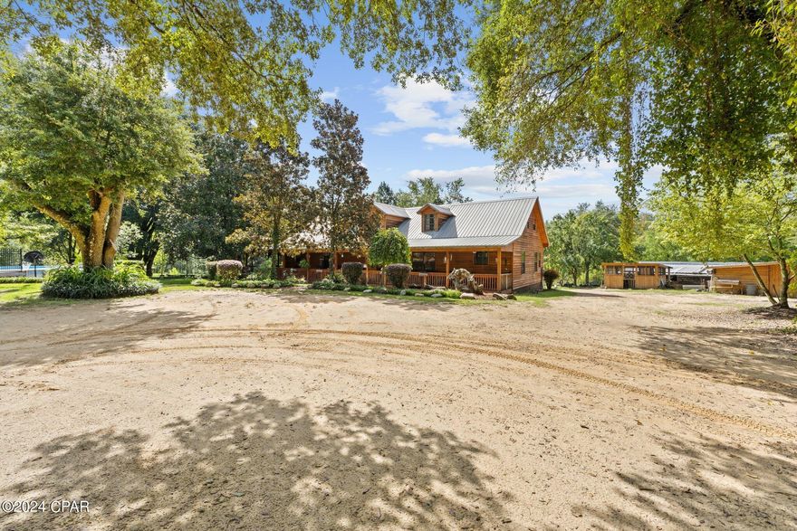 Discover serenity and seclusion on this beautiful 3.69-acre property featuring a charming cabin surrounded by nature. This unique retreat boasts two picturesque ponds, one of which is spring-fed, providing a tranquil setting. Upon entering the cabin, you're greeted by a large entryway leading to a spacious loft. The kitchen is perfectly sized and includes a large walk in pantry. The cabin offers generous bedrooms, ideal for expanding families or peaceful getaways.

Perfect for a campground or family retreat, the property includes several storage buildings and a large 48x36 barn with ample storage and an air-conditioned work area, located behind the pond. There is also a raised flower bed, adding to the property's charm. The 36x24 boat barn, which can hold three boats, is equipped with electricity, providing convenient access and utility for water activities. A four-dog kennel is great for hunting enthusiasts, and the large cook shed is perfect for outdoor cooking.

Nestled amidst the scenic pond area, this retreat is ideal for family reunions and events. Less than an hour from Ft. Novosel and an hour and a half from Panama City Beach, FL, the property is also near several lakes, creeks, the Choctawhatchee River, and springs, making it perfect for nature lovers and outdoor enthusiasts. Don't miss out! Schedule a showing today to experience this exceptional property for yourself. Contact your realtor for more details.