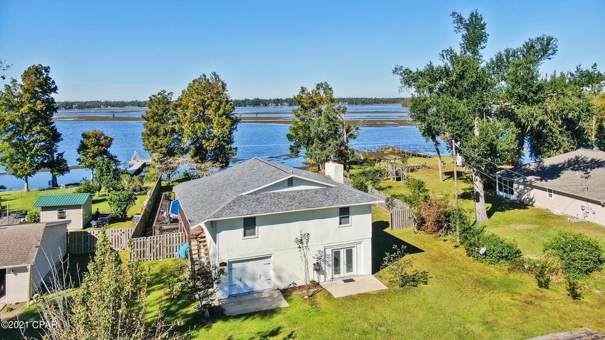'CURRENTLY UNDER CONTRACT, SELLER ACCEPTING BACKUP OFFERS 'Waterfront home on Deer Point Lake with a million dollar view!!  Welcome to this renovated home since Hurricane Michael which includes a new roof, new HVAC system, complete new kitchen, new doors and windows, privacy fenced back yard, hardwood floors throughout, interior paint, new vanities and flooring in bathrooms, plus more.  HUGE in-ground pool and hot tub with a beautiful wood deck.  Jet ski or small boat ramp in your own yard. This split floor home could be used as a home with 2 bedrooms and 2 bathrooms on the second floor plus a 1 bedroom and 1 bathroom on the first floor for a mother-in-law suite, separate apartment or teenager suite. It also has a full living and kitchen area. If you're looking for privacy with gorgeous su