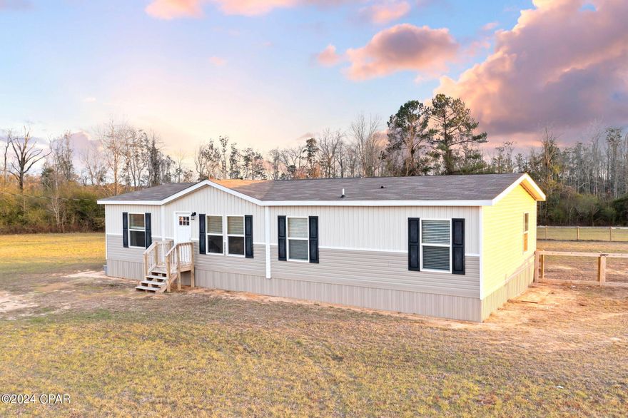 Welcome to your country oasis! This charming mobile home is nestled on a sprawling 18.2+/-acres, offering the perfect blend of tranquility and modern comfort. With 4 bedrooms and 2 bathrooms, this residence provides ample space for families to thrive. Step into the heart of the home, where the living room is a focal point, adorned with custom wall detail that adds character and style to the space. A well-appointed kitchen awaits boasting stainless steel appliances, an inviting island with a breakfast bar, perfect for morning gatherings or casual meals and a dedicated coffee bar, ensuring your mornings start on the right note. The thoughtfully designed split floor plan enhances privacy and functionality. The spacious master bedroom is a true retreat, featuring an ensuite bath with a double vanity, walk-in closet and a large shower. As impressive as the interior is, the property's true allure lies outside. Whether you dream of gardening, hosting gatherings, riding atv's or simply enjoying the kids play in the fenced backyard, this property provides the canvas for your ideal lifestyle.