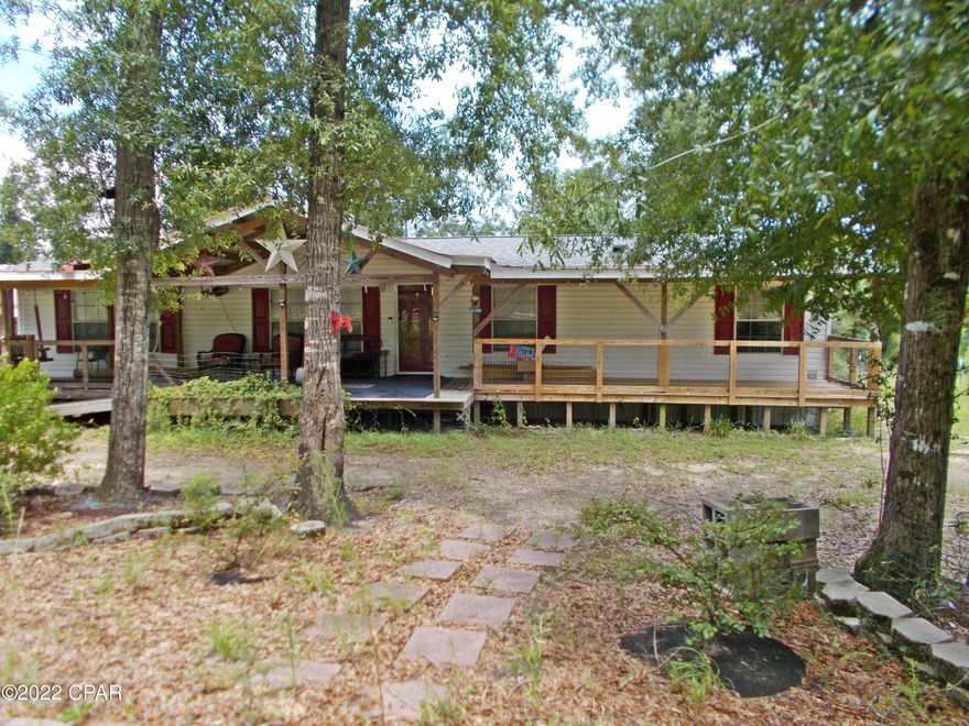 Large updated mobile home, roof replaced after hurricane Michael, lots of room, large living room, large den very large kitchen, large master bedroom, tile walk in shower in master bath, double vanities, large master closet,  There is a new heat pump system ,the home has a cover front porch all the way across the front with 2 back porches, large pole barn, work shop with power, cabinets workbench peg board and two additional storage sheds, over 1.5 ac, quite country setting, call agent to view today.