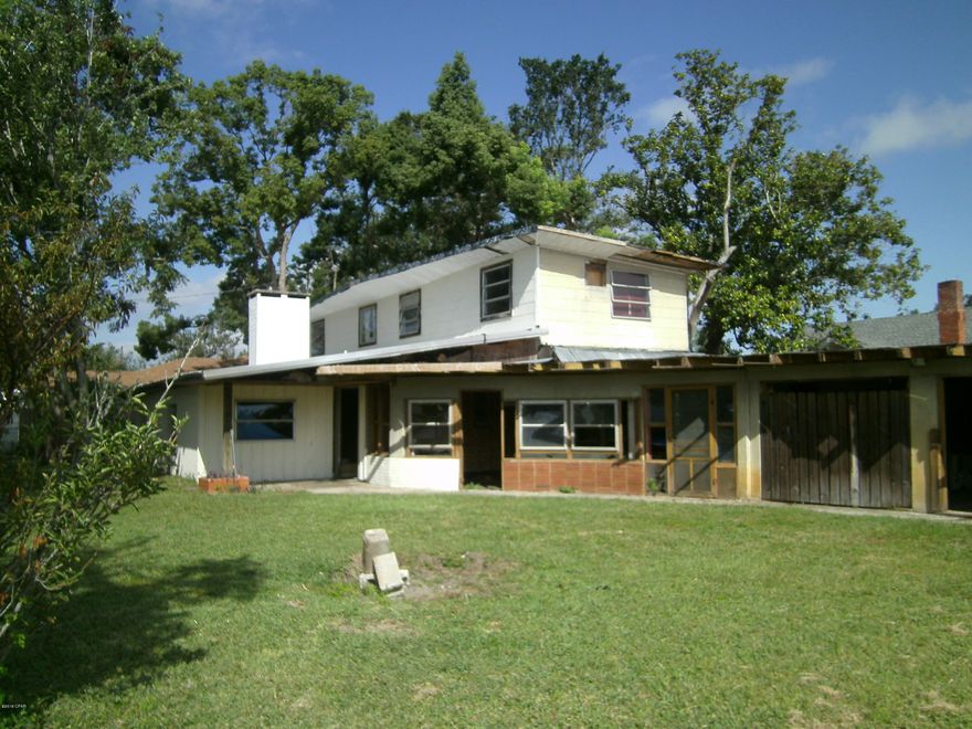 This large Saint Andrews single family multi generational home is approximately 2680 SQ FT! The spacious floor plan is a duplex with the exception of entry into each other from the second floor and basement. Could possibly be converted to a duplex? There is 2 car carport and partially enclosed patio attached to the  east side. Each living space has a large great room with a vaulted ceiling and fire place, private eat in kitchen, dining room, 2 bedrooms 1.5 baths and basement. Seller says roof is water tight, drywall and insulation have been removed. This property is ready for the savvy investor to quickly remodel and flip or rent!! GREAT LOCATION only 3 blocks from beach drive and 1 block from Oakland Terrace Park!  Walk to Historic Saint Andrews restaurants, shops and marina!