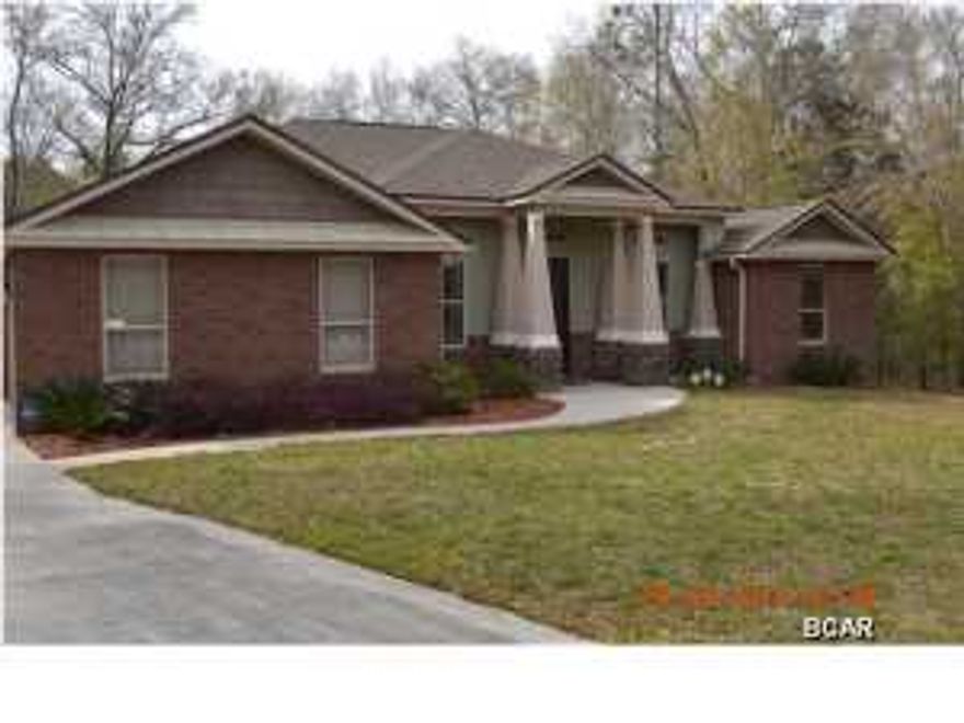 Custom built home located in a serene country setting, close to town, Tyndall Air Force Base and Deer Point Lake. This 3 bedroom, 2 bath home was built by a custom home builder for his family so you know that it was built with details in mind! The interior of the home is an open concept with a great room and kitchen as the focal point of the home. The kitchen has granite counter tops, custom cabinets, stainless appliances and a large kitchen island all open to the living room with a fireplace and built in cabinets. Hand scraped wood floors are throughout the living room, kitchen and formal dining room. For added eating space, there is a breakfast bar on the kitchen island AND a separate breakfast nook. There is also a study or office just off of the front door that could easily