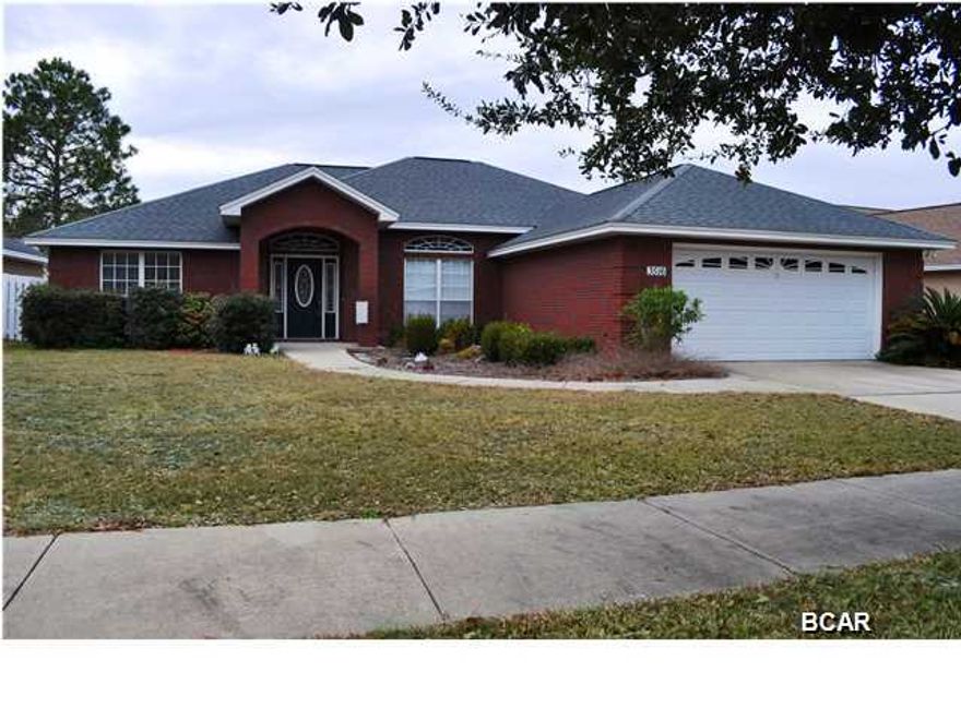 Welcome to the Hammocks! Warm and inviting describes this 3BR/2BA home located in one Lynn Haven's most sought after neighborhoods. This gorgeous home features a Great Room with a gas fireplace, crown molding and Oak hardwood floors. The kitchen has everything a practicing gourmand would need including solid surface countertops, custom oak cabinetry, a roomy pantry, a breakfast bar and a breakfast room. Thanks to a split-bedroom floor plan, the Master suite has plenty of privacy. The ceiling is trayed and the en suite includes a whirlpool tub, double sink vanity, separate shower and a walk-in closet. The two additional bedrooms are quite large and there is a Jack-n-Jill style bath in the hall. Off the back of the home is a lovely screened porch which overlooks the privacy fenced