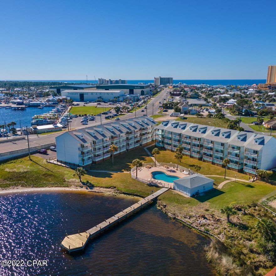 Enjoy beautiful views of Grand Lagoon from your private balcony. This cute and cozy condo is fully furnished and ready for you to enjoy as a full time resident or second home. The kitchen has been updated with stainless steel appliances. Treasure Cove has a swimming pool and dock for those that enjoy boating.