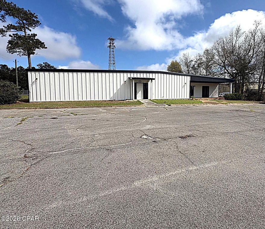 Great Commercial Building located within minutes of I-10 in Marianna Florida with about 1000 sq ft of office space, 4281 HEATED AND COOLED SQ FT of open space for numerous uses and accessable by roll up doors.  Behind the building is about .27 acre of concrete pad, all high fenced and about 30 ft x 184 ft standing seam metal roof, red iron shelter. Then there is a detached concrete block/metal building 26 x 37. NOW THE BONUS: the back .70 acre is not being used and growing in vlonteer woods that could be easily cleaned up for further expansion.
The building has a new metal roof, spray foam insulation throughout the ceiling and new exterior paint,  looks great. In the mechanical room there appears to be some networking in the building. In front of the building/office is adequate parking for 10 vehicles. City water and fire protection. Located in part of the open space of the building is a walk in cooler unit that is 15ft x 36 ft, the refrigerator sytem just needs to be added. This unit could be used for secure storage, cooled storage with refrigerator sytem added or the unit can be removed as it was assembled on site. The County zonig appears to be MUUT, Mixed Use Urban Transitional but need to verify.
2025 property taxes were $2135.46