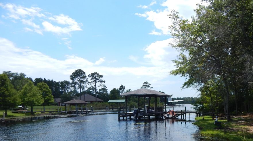 SELLER WILL GIVE A $4000 DECORATING ALLOWANCE TO BUYER---This is a custom built waterfront house with 1.35 acres with a dock- on navigable water at Deer Point Lake. Seller is the original owner & has taken excellent care of this well-built house that has so many features to increase it's value. Full Brick; Metal Roof; Roll down hurricane shutters on all windows; 2 wells; Automatic whole house generator; Raised tray ceilings; fireplace; kitchen island; Corien counter tops; Master bath with separate shower & garden jacuzzi tub. Split bedroom plan; formal dining room; Glassed in Florida Room; 2 separate yard buildings. This house has an abundance of features that will appeal to  Buyers. It has been meticulously maintained and is ready for you to move in & start enjoying lakefront living!Sell