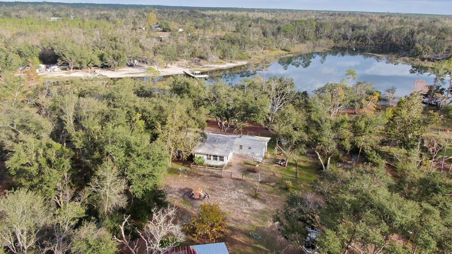 Country Living with beautiful views of Little Blue Pond. This waterfront home sits on 2 acres, offers 2 bedrooms, and 1 bath. Ample storage space with a detached 2 car enclosed carport. Although Not in a HOA, all members in this community have agreed to not allow motorized boats. Bring your canoe, kayak or paddle boat when you move in and fish to your hearts desire!