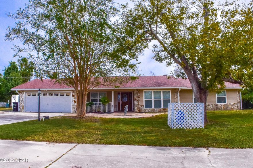 Fantastic 3BR/2BA home on nearly an acre in Parker!  The roof is 2.5 years old, AC new in 2020, & the water heater was replaced in 2017.  Features include hardwood floors, cathedral beamed ceiling, fireplace, huge walk-in closet off the master bath, & a very roomy Florida room.  The kitchen boasts stainless steel appliances, granite countertops &  custom cabinets.  Bonus room up @ front of home would make a great home office/music room or even as a 4th bedroom if needed.  There is a 2- car garage & a circular driveway so parking is never be an issue.  The backyard is spacious & there is room for a pool, workshop, etc. You're less than 5 minutes from Tyndall AFB, schools, shopping, etc...  All info is approx and must be v