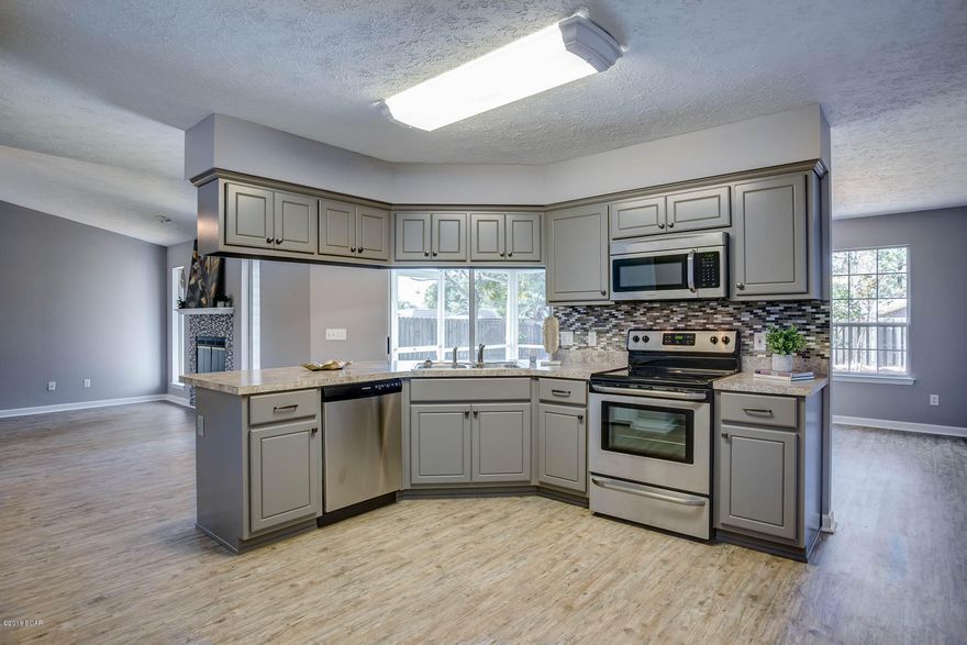 Looking for the feel of a new house?  Check out this three bedroom, two bath garage house that has improvements such as a new roof, new AC, tiled front porch, tiled screen porch, fireplace with eye catching tile, new cabinets with tile backslash, new flooring, new stainless steel appliances.  This house also has a two car garage and is located in the Brittany Woods Park Subdivision convenient to shopping, restaurants, schools and Tyndall Air Force Base.  Just a short drive and you will be enjoying Mexico Beach.  Call today as this house won't last long.   All information contained herein is believed to be accurate however the buyers assumes complete responsibility for verification of all information.