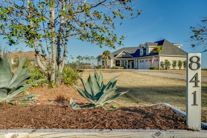 CURRENTLY UNDER CONTRACT, SELLER ACCEPTING BACKUP OFFERS Check out this WATERFRONT DREAM HOME   on the mouth of Laird Bayou in the prestigious gated community of Laird Bayou. You won't want to leave this gorgeous home but should you need to it's just a short drive to shopping, approximately 15-minute drive to Tyndall AFB and about 15 minutes to Eastern Ship Building; Desire a peaceful white-sandy beach to relax on...take a ride over to Mexico Beach. This great community has it all.  It's gated, has a community pool, boat, trailer, and RV parking, and a private boat launch that will accommodate large boats so that you can easily get your boat in and out of the water for maintenance. The exterior of the home features beautiful landscaping, an oversized driveway so that you can easily pull in and out of the  2 car garage plus an additional golf cart garage. There are two extra storage areas inside the garage allowing for plenty of space to store yard equipment, tools, etc. The home also features a Generac whole house generator so you don't have to worry about basic needs during hurricane season. There is a boat dock with lift (10,000lb lift) that will accommodate up to a 22-24 ft boat and also features electricity and water, as well as a floating dock so that you can easily get your kayak, paddle board, or canoe in and out of the water. Take the boat out for a sunset cruise or fishing trip in the bay or gulf and pull right on up to your back door when you are done. Don't want the day to end there.. no problem.. The screened in pool and patio area helps keep debris out and makes for the perfect place to entertain guests any time of the year. You're sure to love the outdoor gas grill and bar with pass through window to kitchen while preparing the days catch. The pool features a beautiful paved deck, a waterfall and tanning ledge that is perfect for small kids to play on or to keep you cool while taking in the sun. The kids will have a blast playing in the pool and running thru the misting hose on the edge of the covered patio. Oh and did I mention the stackable glass wall that opens up from the living area allowing you to enjoy the outside while sitting on your sofa? The interior features a great open floor plan with water views from just about every room in the house including the master bath. There are 3 large bedrooms and 3.5 baths plus an office that could easily be turned in to a 4th bedroom if needed. The upstairs bedroom is perfect for guests/or teenage kids and features its very own full bath. The master bedroom is large and features an en suite fit for a king/queen, with separate sinks, a beautiful soaker tub that over looks the bayou, a large walk in shower with sauna/steam feature, and a huge custom closet that you will have no problem sharing with direct access to the laundry room. The owners have thought of everything with this floor plan. Note: All the bedrooms have custom closets. Love to cook? You will in this kitchen. This is a chefs kitchen and features a Mongram Freestanding Professional Gas Range with dual oven (WOW), GE stainless steel dual icemaker refrigerator, beautiful granite countertops with a large island, a wine cooler, under cabinet lighting, tons of cabinets and counter space as well as a 8.10'x5.5' pantry plus more.... The mudroom is the perfect size and also has built in cabinetry. This home has so much to offer you will need to see it to appreciate it. There is a place for everything in this DREAM HOME. Call your Realtor today.