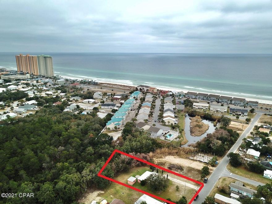 'CURRENTLY UNDER CONTRACT, SELLER ACCEPTING BACKUP OFFERS Are you searching for a half an acre on the Beach?  Look no further you don't want to miss your chance on this incredible property! This house sits on a near half acre lot, and boasts over 1,100 square feet of living space. It's also less than 800 feet from the beautiful white sandy beaches. The house has been split into a two bedroom one bath on the front half and a one bedroom one bath on the back half. The home can easily be converted back into a 3 bedroom / 2 bath! The front portion is currently rented on a month to month basis. The remaining one bed one bath is vacant. Great rental opportunity. There's also a large storage building on the back part of the property. Bay County Planning and Zoning deemed the property R-2 Residential and property can be split into multiple parcels! Don't miss out on this investment opportunity! Schedule your showing today!