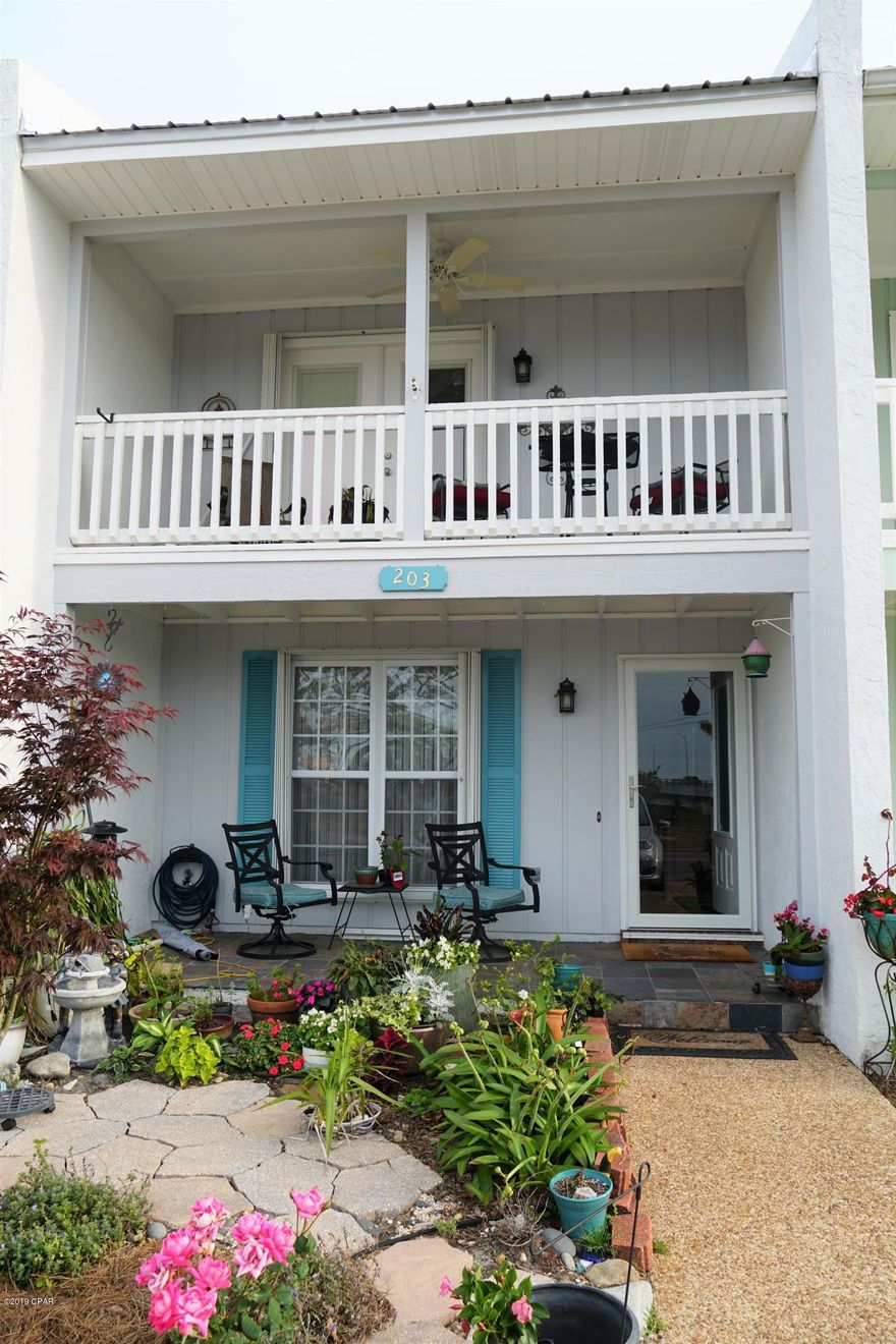 CURRENTLY UNDER CONTRACT, SELLER ACCEPTING BACKUP OFFERS.   Adorable 2/2.5 town home right across the street from city park on the water.  Home is in immaculate condition...has new metal roof, appliances, water heater, paint, and floor covering. Landscaped beautifully in the front and features a sun room attached in the back of the home with access to private outdoor sitting area. Priced to sell and easy to show! Make your appointment today!!