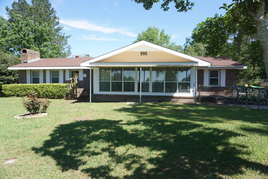 ''Live in the Country'' and keep your cars clean- paved all the way into your large, 3-sided carport! Gated and fenced 3 bedroom, 2 bath 1,932 sq ft bricked home. Many oak kitchen cabinets and 2 towers of drawers, large master suite, large family room with beautiful, sitting hearth, wood-burning and optional gas fireplace.. New energy efficient 5-ton heat pump/air conditioner and hot water heater. Lots of storage throughout the house! Also included: front-load washer, dryer, refrigerator with water/ice dispenser, dishwasher, stove & microwave. Enclosed locking work shop in the carport. Also, 3-sided cover for mower, bikes, toys, etc. attached to carport. Lots of concrete for kids to play & enough room for a basketball court. Large fenced in area right outside the back door for your family pet. Nice, big front yard and back yard with lots of trees for shade. Big, chain-linked fenced back lot perfect for horses, or large garden, with a 3-sided small barn for horse or yard and garden equipment. Lots of room and privacy and move-in ready!