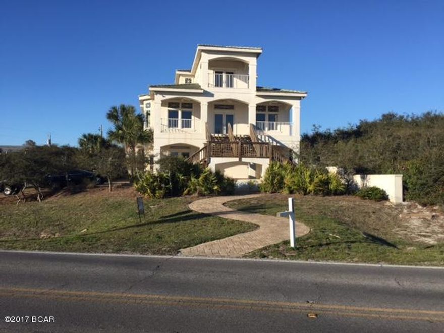 This three-story home is located right on 30A with views of the Gulf of Mexico from the second and third floors.  The first floor consists of a room, casual den, three spacious bedrooms and two bathrooms. The second floor consists of an elegant living room and master bedroom with master bathroom. The third level consists of an open sitting/sleeping area and separate bath.  This property boasts guest quarters above the spacious two-car garage as well as a separate changing room and bathroom at the pool. Home features a guest house & pool with hot tub. Please verify room measurements if important.