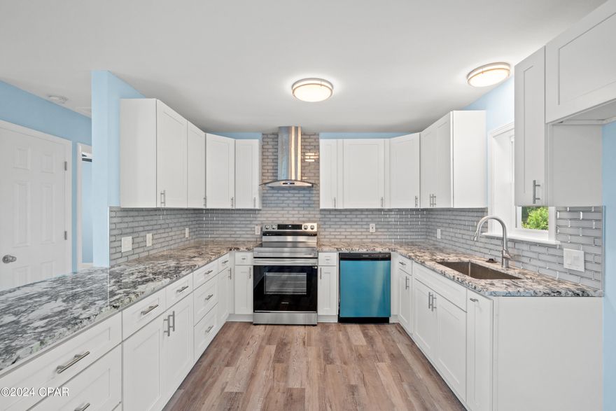 HERE IS AN AMAZINGLY RENOVATED CLASSIC BRICK RANCHER THAT HAS BEEN EXPANDED TO A 4 BEDROOM 3 FULL BATH HOME WITH TWO EN SUITES! JUST WOW ON THIS INTERIOR TRANSFORMATION! ALL NEW INSIDE WITH NEW CABINETRY, GRANITE COUNTER TOPS, LIGHTING, TILE SHOWERS AND LVP FLOORING! NEW VINYL CLAD WINDOWS, HVAC and new roof after Michael.  READY FOR NEW OWNERS! Affordable living walking distance to a park and playground, this level lot home has a large enclosed sunroom on the back and is connected to city water but also has a well for watering lawns, gardens etc. Minutes to Bay county beaches, parks, restaurants and fun in the sun! Close to TYNDAL AIR FORCE BASE, GREAT FOR OUR AF FAMIILIES! Let this be your home away from home or your full time lifestyle ! You cannot beat the timeless durability of a brick ranch style home. These renovators spared no expense on the interior and have added the most popular appliances, colors, tile and granite upgrades. found in much more expensive homes! Call today and let's GET STARTED ON YOUR DREAMS!