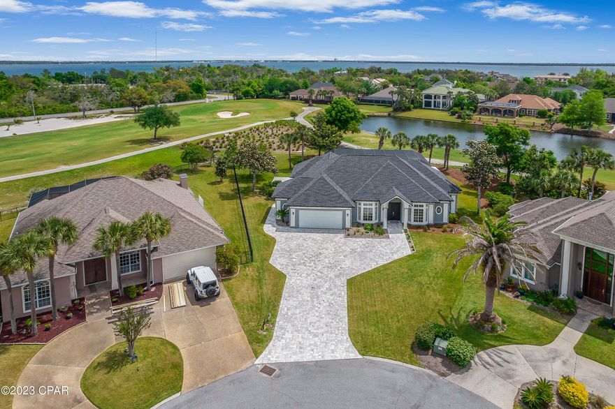 Beautiful 4BR/3BA home located on the end of a private cul de sac in the highly desirable gated community of Bay Point, Legend Hills. Welcoming you with a newly pavered driveway and luscious landscape as you arrive. This remarkably clean and well maintained home has a split floor plan, 2 fireplaces, an oversized 2.5 car garage which has a 100sqft private heated and cooled room that could be used as an office, hobby room, temperature controlled storage and so much more! High custom plastered ceilings and luxury vinyl plank floors throughout gives it an open, airy and seamless look. The kitchen has custom shaker cabinets with quartz countertops, stainless steel appliances, farmhouse sink with RO purification system and a newly tiled backsplash. A spacious master bedroom offers custom motorized shades and views with access to the HUGE screened in backyard oasis! Enjoy this 60x34ft screen enclosure while overlooking hole #10 of the Nicklaus Course. There is even an additional 41x16 covered porch area of back patio to entertain guests and loved ones. This home offers everything you would want and more! New AC units with purification system inside and out, gutters and drains, custom draperies in the dining room and bedrooms, newer roof and exterior paint to name a few more. Bay Point Marina is around the corner while the beach and state park are minutes away. Come see it today!