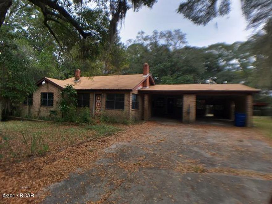 Tucked away on a dead end street, this sprawling ranch home is surrounded by trees and sits on a huge lot 2.3 acres! Beautiful, peaceful setting in the heart of downtown Panama City! This property goes way beyond the fence deep into the lush woods with a creek running through, giving amazing potential for further development. Walking distance to the downtown area with the many shops, restaurants, and cultural events just enhances the value. Great possibilities to make this solid brick home perfect for your family. The huge family room has built in bookshelves and desk that span the entire wall. The large living room is graced with beautiful hardwood floors that reflect a glowing fire in the stone fireplace. In addition to the living room and family room is a den, 3 bedrooms, and 2 baths. Come see all the possibilities