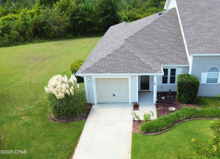 CURRENTLY UNDER CONTRACT, SELLER WILL CONSIDER BACKUP OFFERS Welcome to The Hammocks—one of Lynn Haven's most sought-after family-friendly communities! This beautifully maintained 2-bedroom, 2-bath corner-lot townhome is designed for effortless living with both elegance and everyday convenience, all on a single story with extra windows that fill the home with natural light. Thoughtful gardening around the property even attracts butterflies, creating a peaceful little sanctuary right outside your door.

Inside, you'll find contiguous bamboo engineered wood flooring throughout that adds warmth and style, along with upgraded plantation shutters for timeless charm and privacy. The modern kitchen boasts stylish cabinetry, granite countertops, a breakfast bar, and a cozy breakfast nook—perfect for morning coffee or casual meals. The appliances include a new refrigerator, dishwasher, and a rarely used oven, ensuring a like-new experience. Additional upgrades include new energy-efficient windows, a new water heater, and a roof replaced in 2019. With its immaculate condition and single-owner pride of care, this home is truly move-in ready.

The open layout is ideal for both everyday living and entertaining. Step out back to a screened-in porch that overlooks serene green space and a wooded preserve—offering rare privacy with no neighbors behind you. For those with a green thumb, a charming backyard garden is ready to enjoy.

Life in The Hammocks means low-maintenance living at its best. The HOA takes care of landscaping, irrigation, pressure washing, termite bond, and common area insurance—plus you'll have access to the sparkling community pool, the perfect spot for relaxing weekends, summer parties, or simply letting the kids burn off energy.

Families will love the convenience of being just a short walk to top-rated schools like Mosley High and Bay Haven Charter Academy. Shopping, dining, and everyday conveniences are only minutes away, and the sugar-white sands of Panama City Beach are just a 20-minute drive.

With its upgrades, immaculate condition, and unbeatable location, this townhome is the ideal choice for those seeking a low-maintenance lifestyle without compromise. (Buyer to verify dimensions if deemed important.)