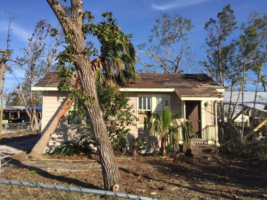 Nice fixer upper, small cottage on deep, chain link fenced lot. Good investment property. Zoned Mixed Use-1 which allows for construction of another separate unit (accessory unit) in the back. Lot is over 200 feet with electric remote gate to back yard. This quaint little house would make a good rental or after repairs would be an ideal starter home! An interior wall, 2x4 and a top beam between living/dining area needs repair/replacement from roof leak. Ceilings need replacement. Needs a new roof. See photos.