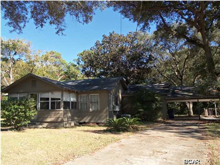 Quintessential St. Andrews home! Loads of charm and character in this large home on an almost 1/2 acre corner lot. This home offers great light, lots of windows, large living room, built-in bench in small sitting room, enclosed front porch, 3 bedrooms, 1 full bath, 1/2 bath in the laundry room, oversized pantry, large eat-in kitchen and an attached 2 car carport. This home has so many unique features. The large shady corner lot features decks, a screened free-standing porch, small greenhouse, fenced yard and a workshop. Lots of storage inside and out. Loads of potential. (all sizes approximate and taken from public records, buyer to verify any details buyer deems important).
