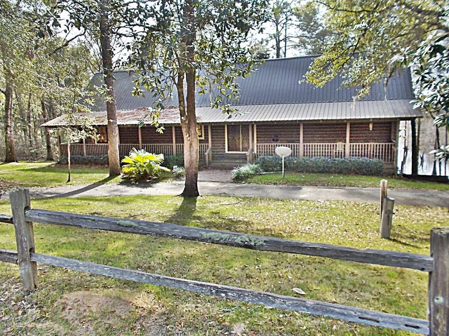 CUSTOM BUILT CYPRESS LOG HOME ON COMPASS LAKE!!! 

This home is a must see!! It has a 24x24 living room with 20ft open beamed ceiling, hardwood floors, tongue and grove walls throughout the home, beautiful stone fire place,French doors and massive glass windows overlooking Compass lake. The kitchen has granite counter tops, cabinets with roll out  and 3 lazy susans.  The master bedroom is on the main floor with a beautiful view of the lake, all wood floors and a large master bath with double sinks, a spa tub, walk in shower, and a large walk in closet. The other 2 bedrooms on this floor also have their own full bathrooms. Upstairs is a large loft/office with the same view as the living room, view of the lake. Also a bedroom and a bath room up there, The garage is massive with a large 24x24 recreation room down there  with a stone fireplace and a full bathroom. This home is really massive and has so much more to offer, please take time to look at the pictures.  This home is priced really good.