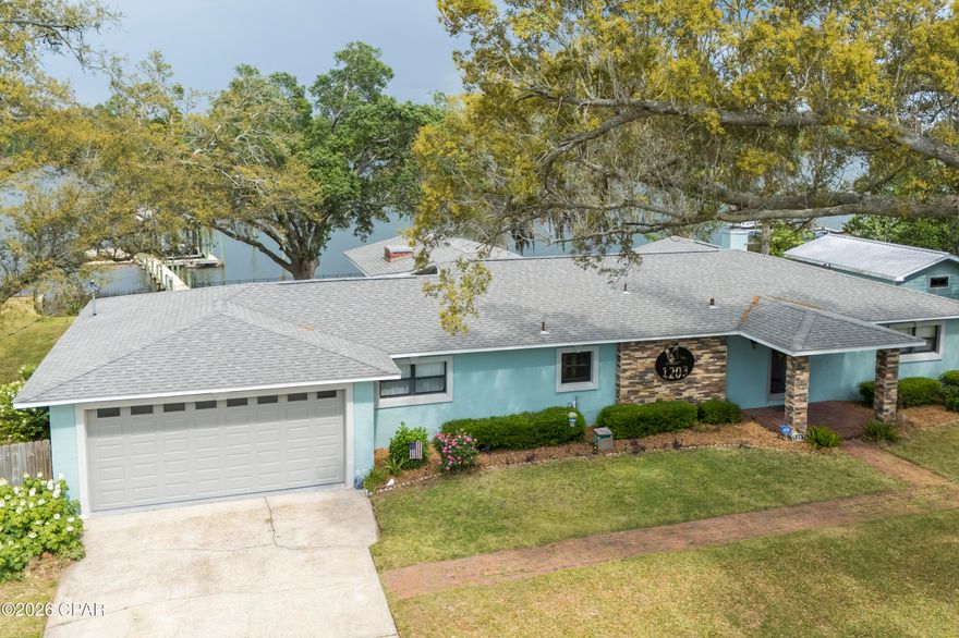 Waterfront Paradise in Lynn Haven - No HOA! This lovely home offers 3 bedrooms, 3 baths with a flex room that is perfectly situated on the water in the desirable College Point Subdivision. Enjoy direct access to the Gulf from Mill Bayou with your own private covered boat dock and lift, ideal for boating, fishing or simply soaking in some sun. Everyday there's an opportunity to watch nature in your own backyard, the best are the dolphins and the pelicans that make their rounds! This beautifully maintained property also features a large screened-in porch and an open deck that's perfect for year-round entertaining. The backyard paradise also offers a large storage shed for all your gear and is shaded by majestic canopy oaks that provide natural beauty and comfort. This home has a double car garage and has spacious parking with a side yard for an RV or a boat trailer. Inside, you'll find a spacious, open floor plan with water views from just about every room, ample natural light and a blend of comfort and style throughout. Having no HOA, gives you the freedom to truly make this home your own. Don't miss this rare opportunity to own a piece of waterfront paradise in one of Lynn Haven's most sought-after locations!