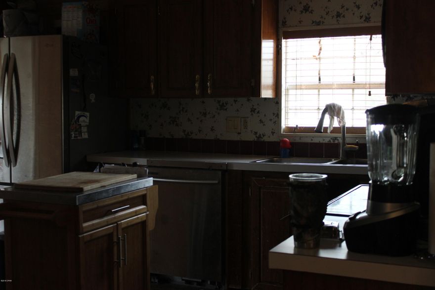 This is a three bed, two bath house with two additional bedrooms in the Florida room.  Two large bath rooms with large kitchen, dinning and family rooms. With an acre in a rural setting, you will have room to store vehicles and boats. Short Distance to Bear Creek and Deer Point Lake.  Home needs a little TLC and some electric work done.