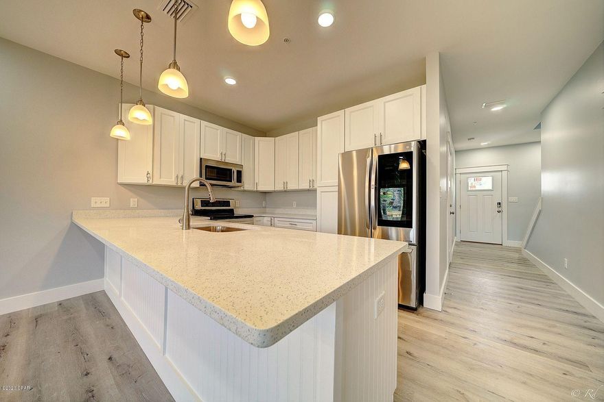 Buyers changed units, so back on market, and READY TO CLOSE!!  Brand new, low HOA fees, & close to the beach in a small 16 unit complex. Welcome to Seaside Heights! This 1580sf, 3 bd/2.5 bath home has it all. From Hardie Board & stone siding, to LVP flooring throughout, 9' ceilings, upgraded solid surface counter tops, and an all stainless appliance (including fridge) package. Smart technology includes electronic front door lock, Ring door bell, and the garage door opener. Home has a sprinkler system for fire safety, and HOA docs will allow short term rentals and owners pets. HOA fees to cover structure, roof and flood insurance, trash removal and grounds keeping. Fees are subject to change once complex is complete. Don't miss this great opportunity.