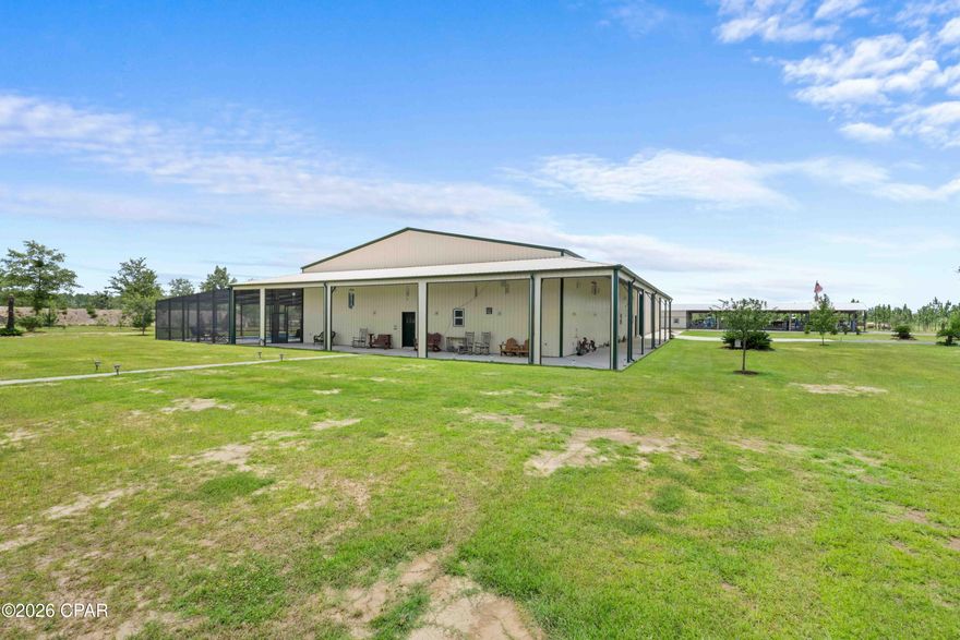 One-of-a-Kind 380-Acre Luxury Barndominium Estate | Recreational Paradise & Private Retreat Welcome to a truly exceptional opportunity -- a 9,600 sq ft fully insulated Barndominium on 380 acres of pristine North Florida land, located just 30 miles from Panama City. This multi-functional estate offers the perfect blend of luxury living, recreational freedom, and income-producing potential. Main Living Quarters (8,400 sq ft Heated & Cooled) 2 Bedrooms + Loft Bedroom | 3 Full Bathrooms Open-concept living with 18' ceilings, custom pine walls, and epoxy flooring Two fully equipped designer kitchens with pine cabinetry, granite countertops, high-end appliances, island seating, and walk-in pantry Spacious master suite features built-in cabinets, surround sound, electric fireplace, private pool access, and an oversized walk-in closet Gas fireplace, two laundry rooms, and four HVAC systems for zoned comfort Tankless water heater for energy efficiency Recreation Wing (6,000 sq ft) Massive 100' x 60' climate-controlled space with three 16' x 12' roll-up doors--perfect for RV or equipment storage Includes a full kitchen, full bath, and 1,000 sq ft storage room Ideal for entertaining, business use, or indoor sporting activities. Outdoor Oasis Resort-style 40' x 20' heated saltwater pool with tanning ledge, waterfall feature, and full screen enclosure 20' x 60' covered carport, covered porches, and landscaped grounds with full sprinkler system Guest house, dog kennel, and 1,032 sq ft insulated/heated/cooled workshop with car lift Land & Lifestyle 380 private acres with diverse terrain: pastureland, hardwoods, deer plots, and stocked ponds (catfish & bream) East prong of Bear Creek runs through the rear of the property Multiple pole barns, 5 shallow wells, 1 deep well, and 2 septic systems Abundant wildlife: deer, turkey, black bear - ideal for hunting or eco-retreat Property is 1 mile deep from State Road 20 for unmatched privacy Endless Potential This estate is turnkey and adaptable for various uses such as private residence, family compound, cattle ranch, equestrian facility, hunting & outdoor retreat, corporate or church retreat center, event venue, festival grounds or data center. Location 30 mi to Panama City, FL 61 mi to Dothan, AL 82 mi to Tallahassee, FL 132 mi to Pensacola, FL All furnishings are negotiable. Shown by appointment only. No expense spared--this is more than a home; it's a lifestyle.