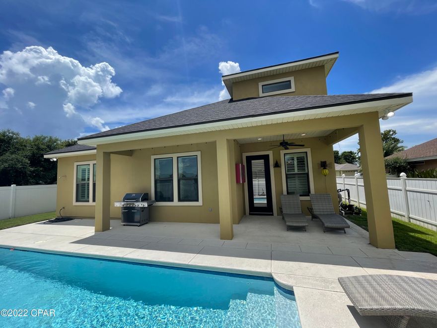 Rare opportunity to rent a luxury home in Summer Breeze on Panama City Beach! Gorgeous mediterranean style 3 BR, 2.5 BA home with in-ground pool, two car garage, and stunning finishes! This home is situated on a corner lot with immaculate landscaping professionally serviced for you. As you enter the custom iron french doors, you will be greeted with tall ceilings, 6'' crown molding, hardwood flooring, and a formal dining room. The floor plan is an open concept with a commercial grade kitchen overlooking the living room and breakfast nook. The kitchen features gas range, built-in gas oven and microwave, granite counters, large island breakfast bar and all stainless appliances. Step out back into the oasis with an inground pool, covered lanai, & on-demand gas connection to grill! The spacious first floor master has plenty of room for large king size bedroom furnishings. Master bath has a double vanity with granite, tub/shower and large walk-in closet. Laundry with washer/dryer and powder room also on first floor; Upstairs is a flex space for a home office, two bedrooms and full bathroom. The home is wired for surround sound throughout for pure entertainment inside and out. This is a must see! Pets negotiable with non-refundable $350 pet fee.