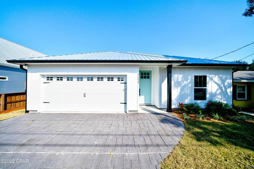 CURRENTLY UNDER CONTRACT, SELLER WILL CONSIDER BACKUP OFFERS | 3 bed, 2 bath BRAND NEW CONSTRUCTION home on the West end of Panama City Beach! Less than half a mile to the white sandy beaches and

short-term rentals are allowed! Every detail was thought of when building this home. This home features a stamped concrete driveway and covered front porch and modern light fixtures. The living room, dining area, and kitchen feature an open floor plan that is perfect for hosting family and friends. The kitchen boasts stainless appliances, quarts counters, a kitchen island with a sink, a dishwasher and a breakfast bar,

white shaker cabinets with soft close features, tile backsplash and recessed lighting. The dining area boasts a beautiful, modern chandelier. The

spacious primary bedroom features a large walk-in closet with shelving and a private primary ensuite bathroom. The primary bathroom boasts a beautiful, modern vanity with quarts counters, a walk-in shower with surround tile and an additional showerhead, a private toilet room, and linen shelving. The additional bedrooms share a full guest bathroom featuring a modern vanity with quarts counters, linen shelving, and a shower/tub combo with surround tile. LVP flooring throughout. The backyard has room for a pool! This home is just a short drive to the white sandy beaches and the desirable 30A community including Alys Beach. This home is also just a short drive to Pier Park featuring shopping, an amphitheater, The Grande Theatre, The SkyWheel and plenty of eye-catching restaurants! Check out this new home today!