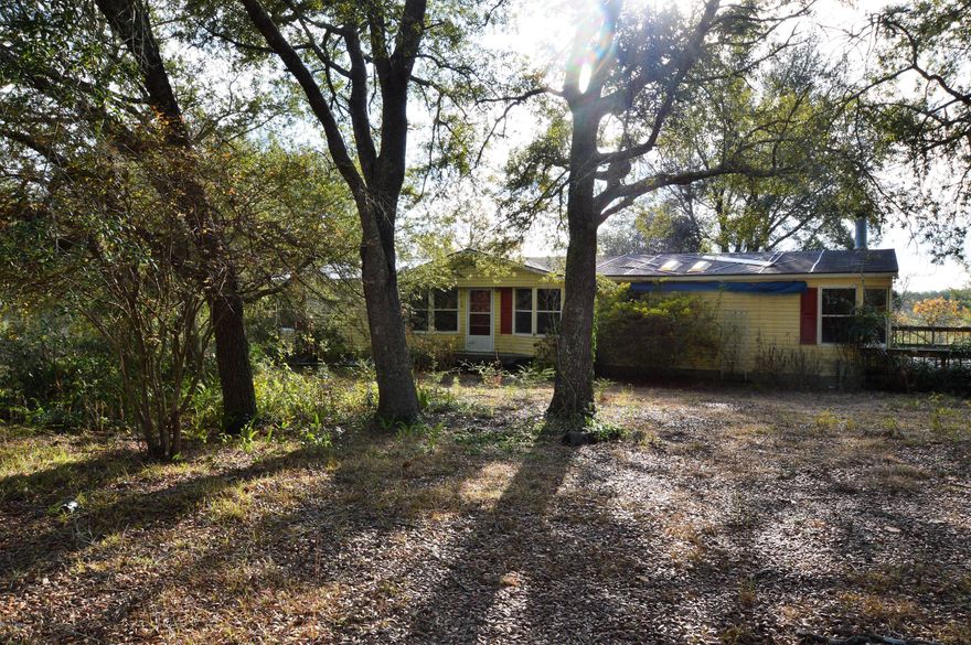 This home has the convenience of being close to Highway 77, but would be perfect for someone searching for a home in the country.  The land features beautiful shade trees!  With some work, this 3 bedroom two bath home could be a gem. Property features a well and septic.
