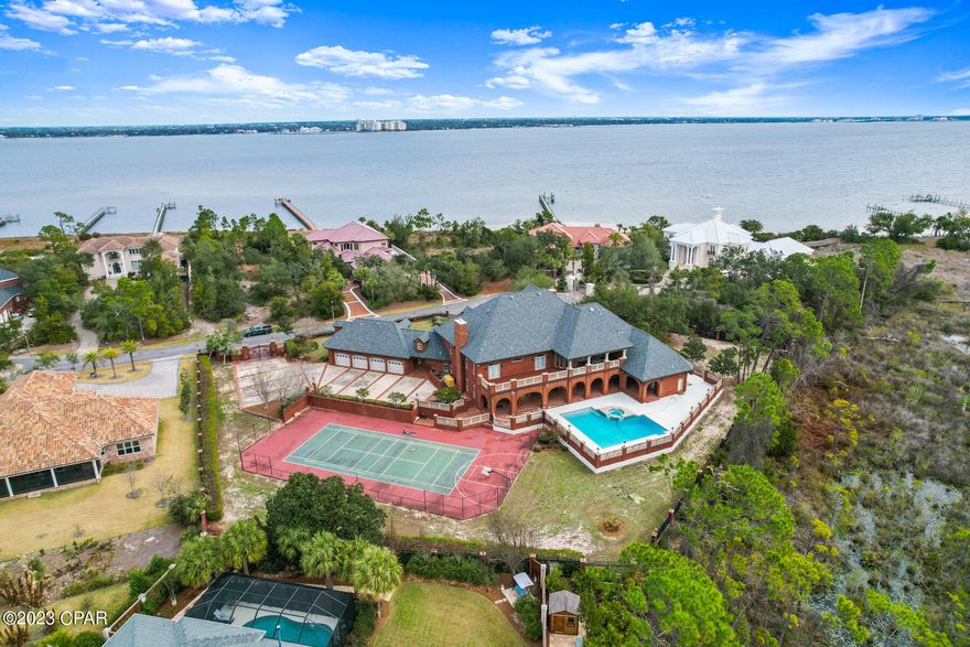 Rare opportunity to own a custom built estate boasting 6 oversized bedrooms and 10 bathrooms. Located in one of Bay County's most exclusive communities, the Preserve on the Bay, this masterpiece includes an outdoor tennis court, an indoor gym, oversized library, a separate mother in law quarters with a full sized kitchen, a movie theatre on the third floor, an oversized 4 car garage, large swimming pool,  high end finishes and more. Nestled on 1.6 acres at the end of a cul de sac and with it's own private gated entrance you'll be sure to find privacy here. This is one you will have to see to believe- excellent opportunity to buy an estate well below replacement cost. Don't wait!