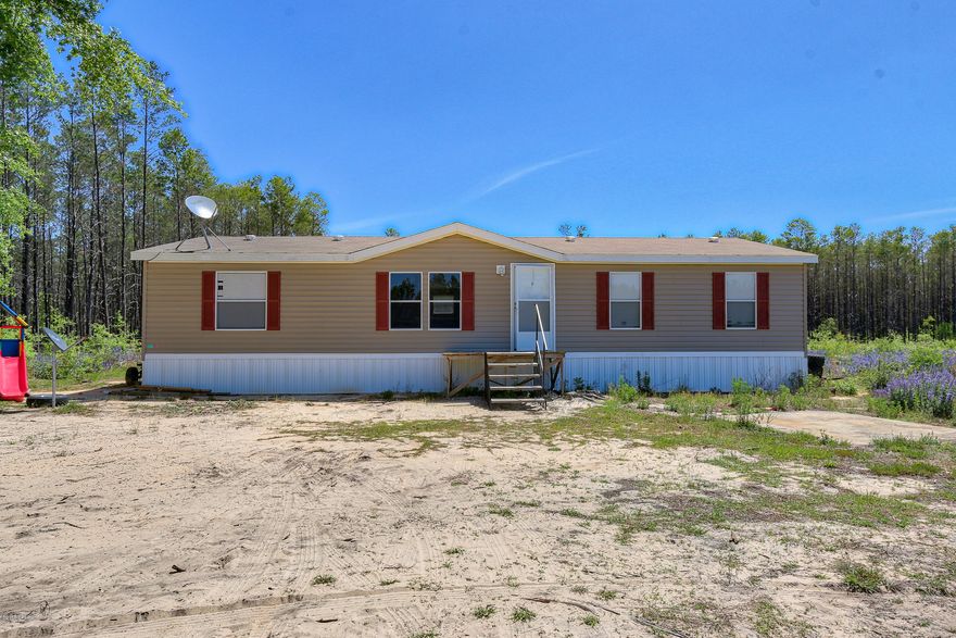 Beautiful, quiet home place on 5 acres of cleared land just a block away from Crystal Lake! This 2015 model home totals 1456 sq ft and features an open floor plan with 3 bedrooms, 2 baths + an additional bonus room/office space that could also be used as a 4th bedroom. A large kitchen boasting a grand kitchen island and plenty of cabinet storage. Master bath features a large bathtub, stand up shower and double vanity. New septic in 2015.