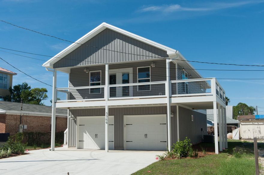 New construction in a magnificent South Lagoon location!   Step inside and marvel at the treyed ceilings and beautiful luxury plank floors! The lighting, color palette, finishes and fixtures have been professionally chosen for that perfect Beach House look and feel! The chef in the family will love the beautiful kitchen with soft-close Shaker cabinets, upgraded granite counter tops, tiled  back splash, and GE stainless steel appliances! The large master bedroom has treyed ceilings and a his-and-hers closets, and the master bath features double vanities and a lovely shower with floor to ceiling tile and a custom glass door! Smart Home features are modern and energy efficient LED lighting throughout, KEEP READING! WiFi enabled garage door opener, WiFi enabled thermostat, and WiFi enabled irrigation! Designer interior colors, a double car garage, fully sodded and irrigated lot, high-impact windows and wonderful views!  Smell the salt air as you step out of your second floor wrap around balcony overlooking the Dolphin Street boat ramp and beautiful Grand Lagoon! Your beautiful new Beach House is nested a quiet golf-cart friendly neighborhood in the South Lagoon area.  Your new home is perfect for the water sports enthusiast, it is literally a one minute walk to the boat ramp and only five blocks to the beach.  Kayaking, paddle boarding, and superb fishing are at your doorstep.
