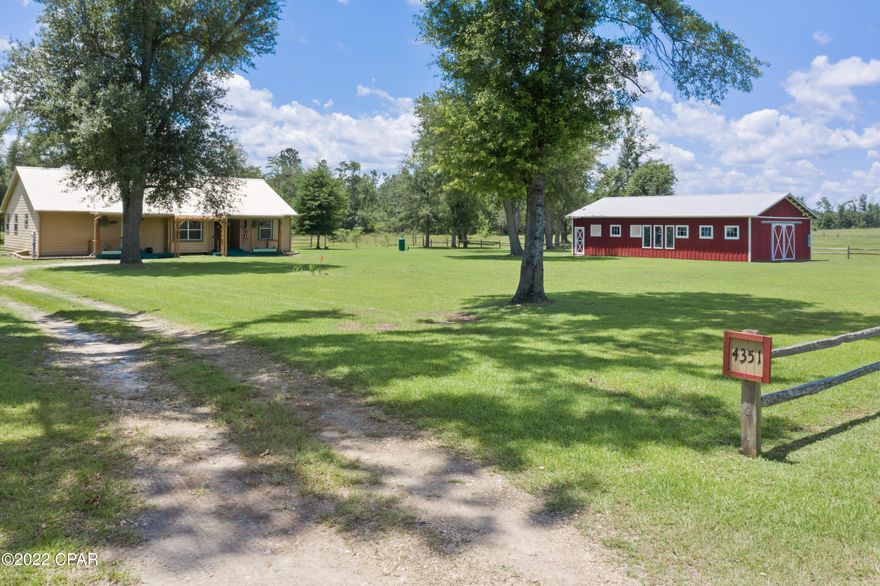 Beautiful 3/2 on a private 5 acres located just outside of town on a dead end lane. Walking inside just feels like ''Home''!  Ground source heat pump means a very low electric bill.  Termite bond with A&J Pest.  Hardwood flooring and high wood ceilings, curb appeal, HUGE workshop.  Walk-in tile shower and large walk-in closet in the master bedroom.  Split bedroom floor-plan.  It's all here. Large laundry room with exit door.  Screened in back porch. If you've been waiting on the house you can wake up in and drink your coffee on the back porch in peace, this is it!!! Make an appointment to see it today!