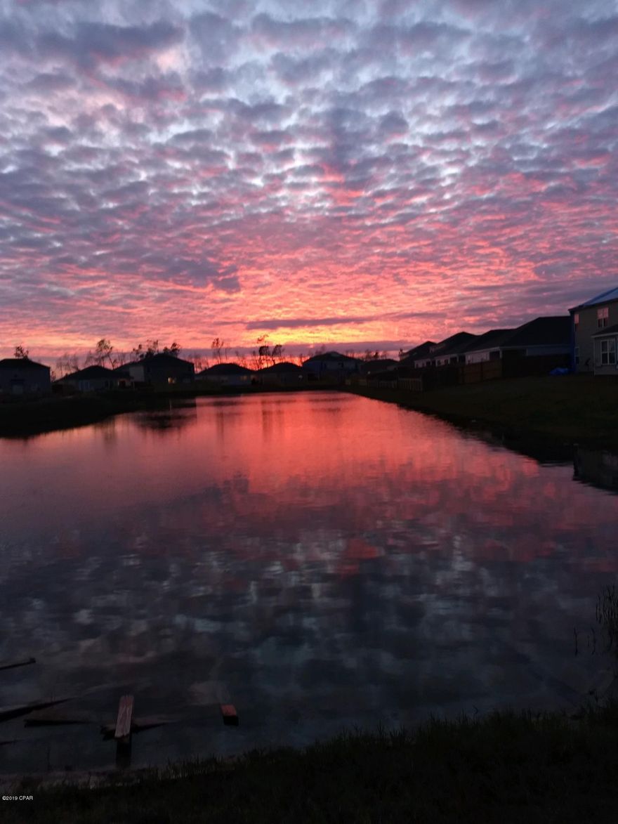 CURRENTLY UNDER CONTRACT, SELLER ACCEPTING BACKUP OFFERS.WOW! Come see this absolutely breathtaking home, located in the quiet and serene Barrett's Park Community in the Olde Towne Village subdivision. This home is unlike any of the others in the area, with the most popular floor plan. The owners have upgraded just about everything in this home, so rest assured you're not getting a builder's grade home.

This home features BRAND NEW vinyl-plank flooring and plush, luxury carpet in the bedrooms. Kitchen displays gorgeous granite and a custom breakfast bar, as well as pendulum lighting, track lighting, a hanging pots and pans rack, AND a farmhouse sink. You'll fall IN LOVE with the large walk-in closet and copious natural light in master bathroom.

The living room is made for entertainment w Home has a NEW roof (with warranty), new vinyl TILT windows, has had a recent CLEAR WDO inspection, recent survey, and is ready for its next family to occupy! Built in 2016, this house is everything you could ever want and more.
Lot sits on an inaccessible, large pond. See photos of the breathtakingly beautiful sunset. Enjoy your morning coffee or evening wine on the marvelous back patio or under the custom pergola out back. The pergola is lit by solar-powered Edison lights, which can be converted to electric if desired. PLUS, home features a TWO CAR GARAGE (a rare find these days!). Storm door on the front, and separate laundry room.
Conveniently located near Hwy 231 for easy access to Tyndall AFB, PC proper, Lynn Haven, or 98 to get to the beach.
ELIGIBLE FOR ALL FORMS OF FINANCING!
HOA is CHEAP! At $121.25/quarter, you just can't beat the price!
Come see this home and make it YOURS today! Hurry! Home won't last long, it's just too good to be true!