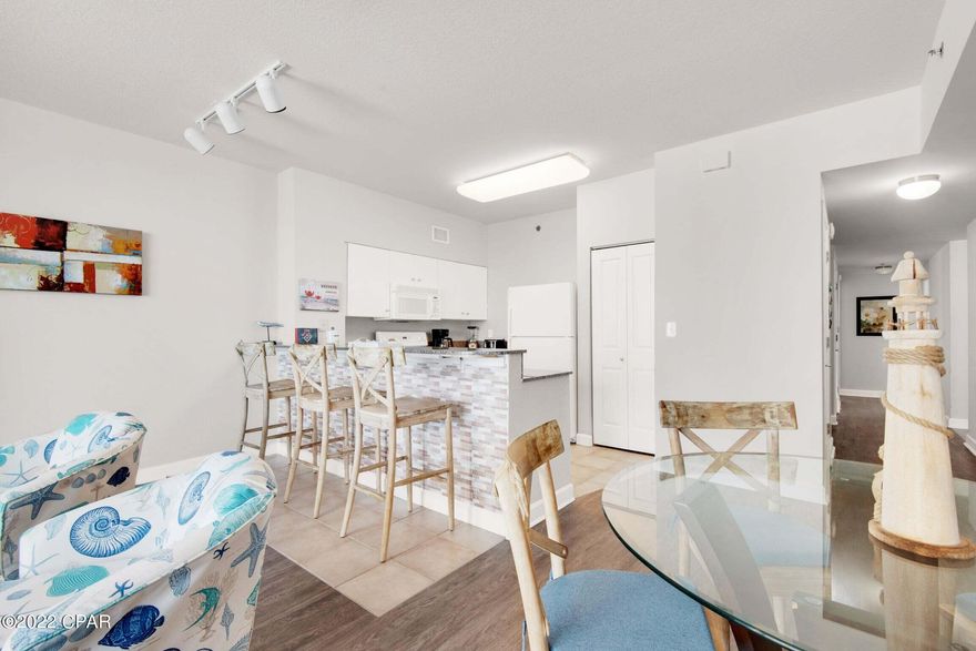 CURRENTLY UNDER CONTRACT, SELLER WILL CONSIDER BACKUP OFFERS. Motivated Seller-bring us an offer! Be sure to check out this fully furnished, turn-key meticulously maintained Shores of Panama condo consisting of 2 bedrooms, 3 baths, plus bunks. The unit features No Carpet-LVP flooring in the living room and bedrooms w/tile in the kitchen & baths. HVAC replaced in 2021 along with the living room sofa and chairs. There is a fully equipped kitchen and a spacious dining area with plenty of room for family and friends. The bunk room has its own private/full bath. Comes with its own dedicated parking spot. Soak in the beautiful views of the white sandy beaches and emerald waters of the Gulf of Mexico. This condo comfortably accommodates 7. This one will make for a great investment property or for your own beach getaway! Shores of Panama is perfectly situated on the beach and features nearly 500 linear feet of beach, a 14,000 sq. ft. lagoon style pool, indoor heated pool & hot tub, tiki bars, fitness center, covered parking deck and more. Loads of amenities and right next door to Pineapple Willy's makes this Gulf front resort a big attraction to so many visitors each and every year. Make this rental machine yours today!