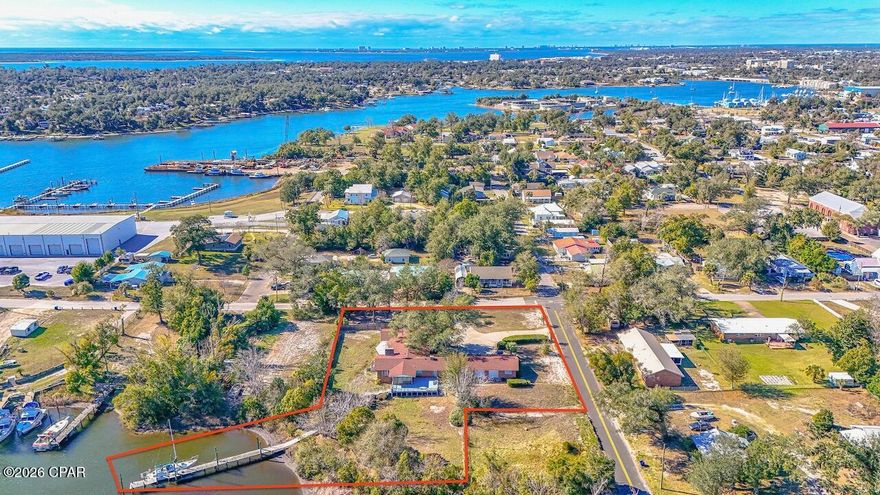 Discover an exceptional opportunity to own a large waterfront estate on over 1.1 acres, just a short distance from the sugar-white sands and emerald waters of the Gulf of America. Offering 4,419 square feet, this expansive 5-bedroom, 5-bath ranch-style home sits on a rare oversized waterfront lot—providing the space, privacy, and potential that are increasingly hard to find along the coast.

The home features a circular driveway, generous living areas, and a spacious deck overlooking the water, creating an ideal foundation for a stunning waterfront retreat or custom renovation. While the property does require updating and renovation, it presents a remarkable value-add opportunity for buyers looking to personalize a large coastal residence or create a one-of-a-kind luxury estate.

With its prime waterfront setting, massive lot size, and proximity to the Gulf, this property is perfectly positioned for full-time living, a second home, or an investment project. Priced under $1 million, this is a rare chance to acquire a large waterfront home and over an acre of coastal land at an outstanding price point.

Bring your vision and unlock the potential of this unique waterfront offering.