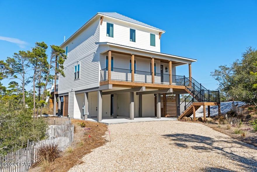 CAPE LIFE AWAITS WITH COASTAL LUXURY WITH WATER VIEWS!! Introducing a 2-story beach house in the gated Seagrass community on the North end of Cape San Blas, offering beautiful Gulf & Bay views in a peaceful, well-planned coastal setting. Completed in 2024, this fully furnished, rental-ready home features nearly 2,900 square feet of living space with modern finishes, quality construction & a layout designed for both comfort & investment potential. The open floor plan is perfect for entertaining, with large picture windows, covered deck access & a spacious living area centered around a cozy fireplace. The kitchen is nicely appointed with granite countertops, decorative vent hood, custom cabinetry & a large island that doubles as a breakfast bar. With 4 bedrooms & 5.5 baths, each bedroom includes a private ensuite & walk-in closet, making the home ideal for large families or vacation guests. An elevator provides easy access to every level. The ground floor includes an outdoor kitchen, dining area, full bath & space that could be enclosed for a fifth bedroom, bunk room or game space. Seagrass offers deeded beach access, community pool, clubhouse & street lighting, all surrounded by natural vegetation near State Park land. The pet-friendly sugar-white beaches of Cape San Blas are known for being uncrowded & perfect for fishing, kayaking, paddleboarding, boating & long sunset walks along the shore. Miles of paved paths make it easy to bike or golf cart the Cape, stopping at local restaurants, beach stores & live music spots along the way. Just a short drive to Port St. Joe, you'll find a charming coastal town filled with boutique shopping, fresh seafood, marinas, festivals & year-round events that make this area one of the most loved destinations on the Forgotten Coast. Whether you're looking for a second home or income-producing property, this one checks all the boxes. Call for your private tour & LIVE THE BEACH LIFE!