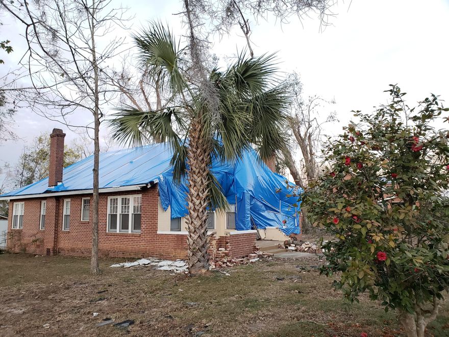 Investors, Contractors, Home Buyers, Home damaged by Hurricane Michael: Livable and repairable.  Will need a roof and construction work.  Owners have decided to not repair and move on.  Lots of potential can be seen in this 1935 Florida home located in the heart of the City of Marianna. 3 BR/2 BA corner lot, in town convenience. Spacious rooms with high ceilings, central heat & air, two fireplaces (inspect before use). Large eat-in kitchen plus formal living or family room and dining room, detached single garage. Minutes to Chipola College, downtown conveniences, Citizens Lodge and medical offices. AS IS ~ please view all photos before showing.
