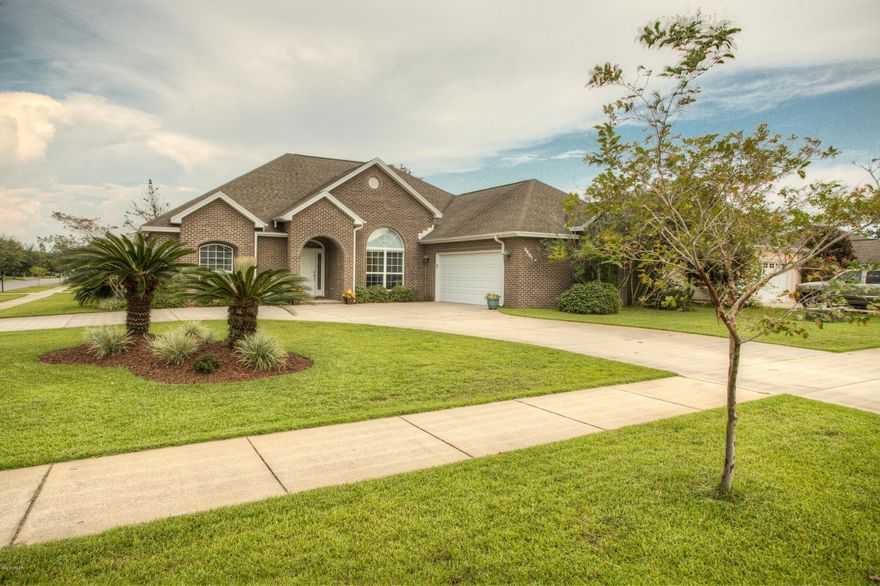 This gorgeous all brick, split floor plan just might be your “Home Sweet Home”.  This home is located on a corner lot in a much sought out subdivision, HAMMOCKS.  The governor’s driveway adds a unique feature.  Located near schools, churches, entertainment and more!  Community pool, sidewalks, and convenient location adds a bonus for any family.  Dining room features laminate floors, crown molding, chair rail and 12ft high ceiling.  Well-designed kitchen with lots of counter space, custom cabinets, stainless appliances, including a self cleaning double oven(refrigerator does not stay), good size pantry, breakfast nook, and island.  Lots of windows offer natural light throughout home.  Master Suite includes large walk-in closets, his/her sinks, large shower and separate Jacuzzi tub. The additional bedrooms are comfortably sized with big closets.  The oversized 2 car garage is perfect for extra storage and the screened in back porch is ideal for entertaining or extra play area.