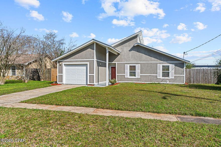 Welcome home to this charming 3 bedroom, 2 bath home offering 1,166 square feet in the heart of Lynn Haven, located in a highly desirable A+ rated school zone. Inside you will find upgraded laminate flooring in the main living areas and cherry hardwood flooring in the bedrooms, along with a vaulted ceiling in the living room that creates a bright and inviting space. The updated kitchen provides a functional layout for everyday living, and the home also includes a single car garage. Step outside to enjoy the covered back porch overlooking the backyard with a cozy firepit, perfect for relaxing or entertaining. Situated in an established neighborhood and directly on the Rails to Trails walking path, this home is just minutes from shops, restaurants, recreation fields, parks, and more.